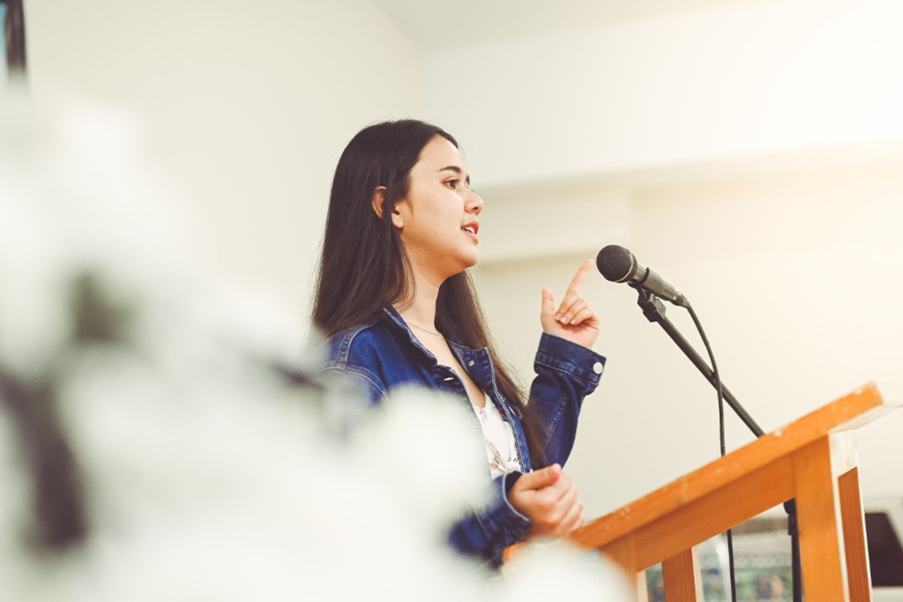 A young woman delivers a speech